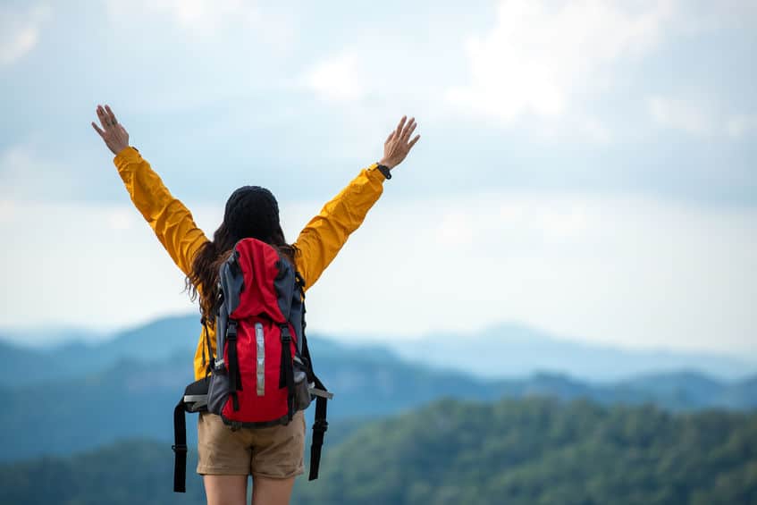 131488075_s Hiker asian women raise hand and pointing happy feeling freedom good and strong weight victorious facing on the natural mountain. Traveler going camping outdoors destination leisure
